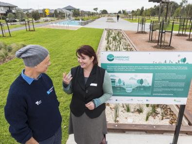 Image shows representatives of Melbourne Water and the community standing at the entrance of Pilot Park, the name of the area that was developed from open culvert to parkland